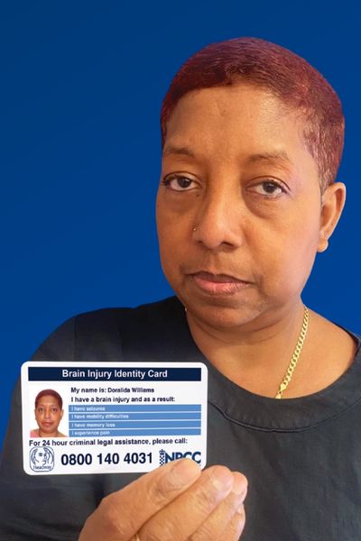 Doralida Williams proudly holds her Brain Injury Identity Card