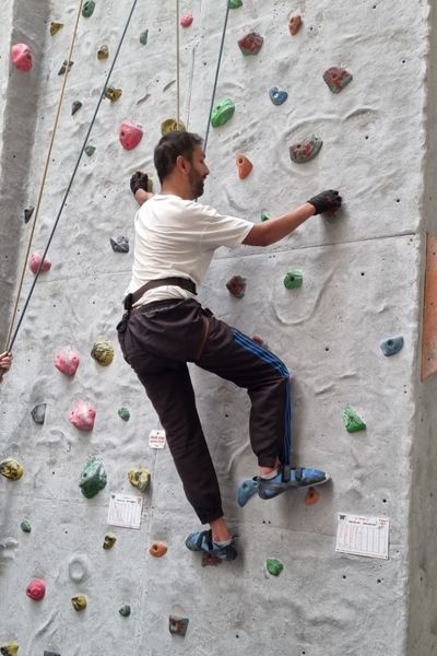 Raj using climbing wall