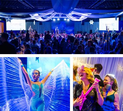 Wide shot of the ballroom, a performer in blue ice costume, and two women at a selfie stand