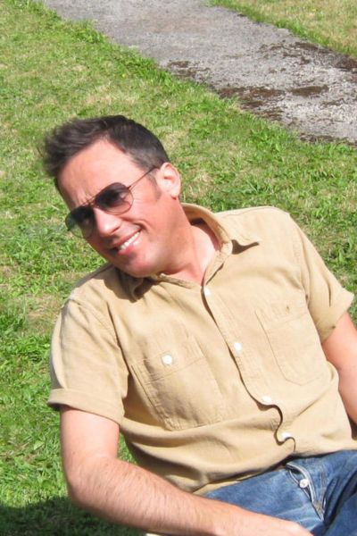 Author Adam Nicke, wearing a beige shirt and sunglasses