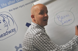 Headway's Training Manager Ed Arnoll writing on a flipboard during his training