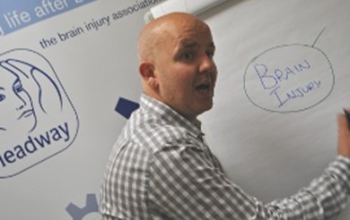 Headway's Training Manager Ed Arnoll writing on a flipboard during his training