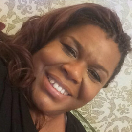 Brain injury survivor Shana Lewis smiles at the camera