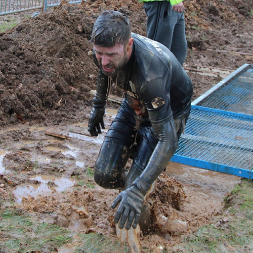 Oli's friend Ric runs through the mud on the Ram Run