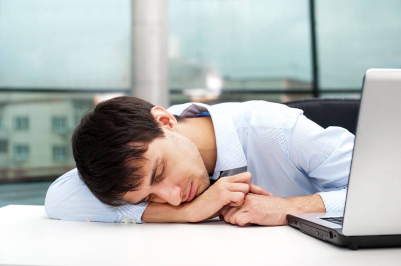 man asleep at a laptop