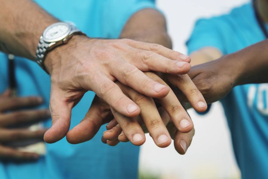 volunteers putting hands together