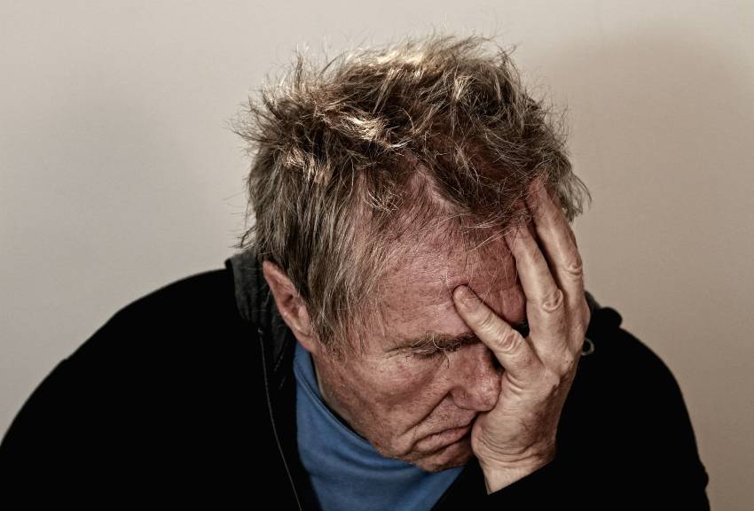 man with head in hands