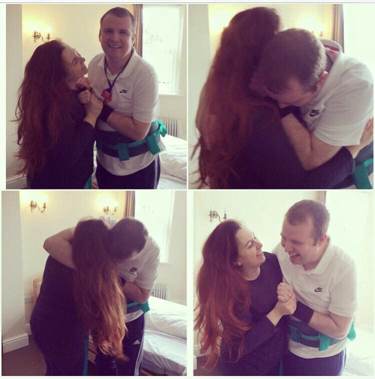 Paul standing for the first time with the help of his sister, Amy