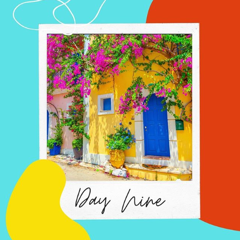 A photograph of a beautiful yellow house covered in pink flowers