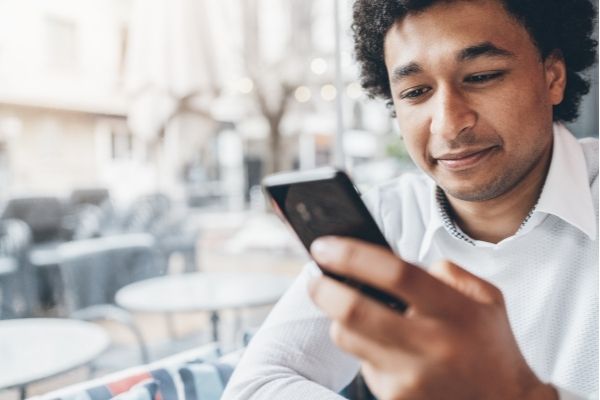 A man reads a supportive message on his phone.