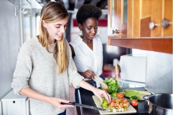 Two friends cooking together
