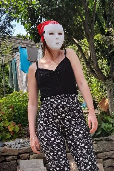 Eleanor May Blackburn wearing one of the masks she uses in the play